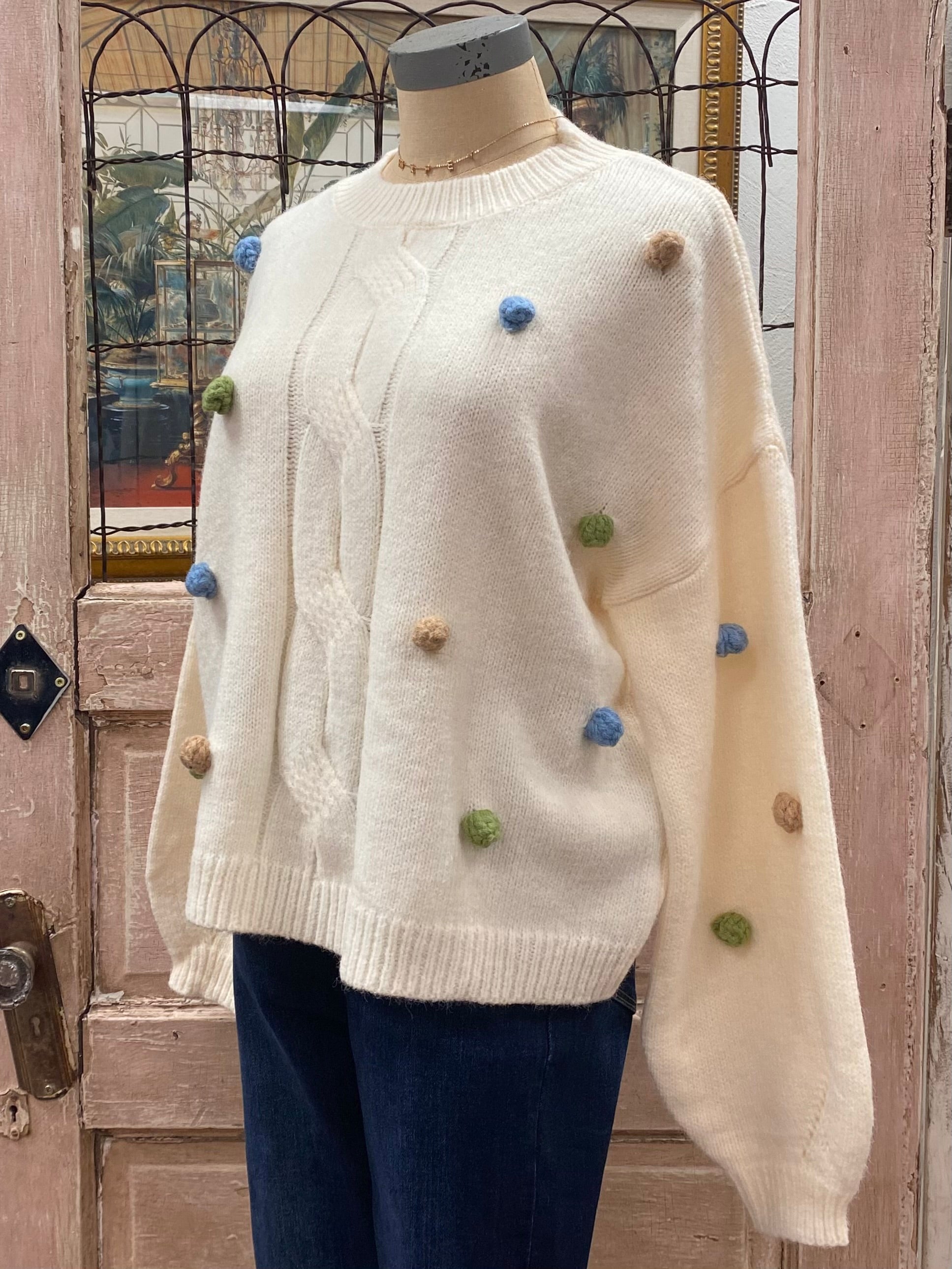 White sweater shop with pom poms